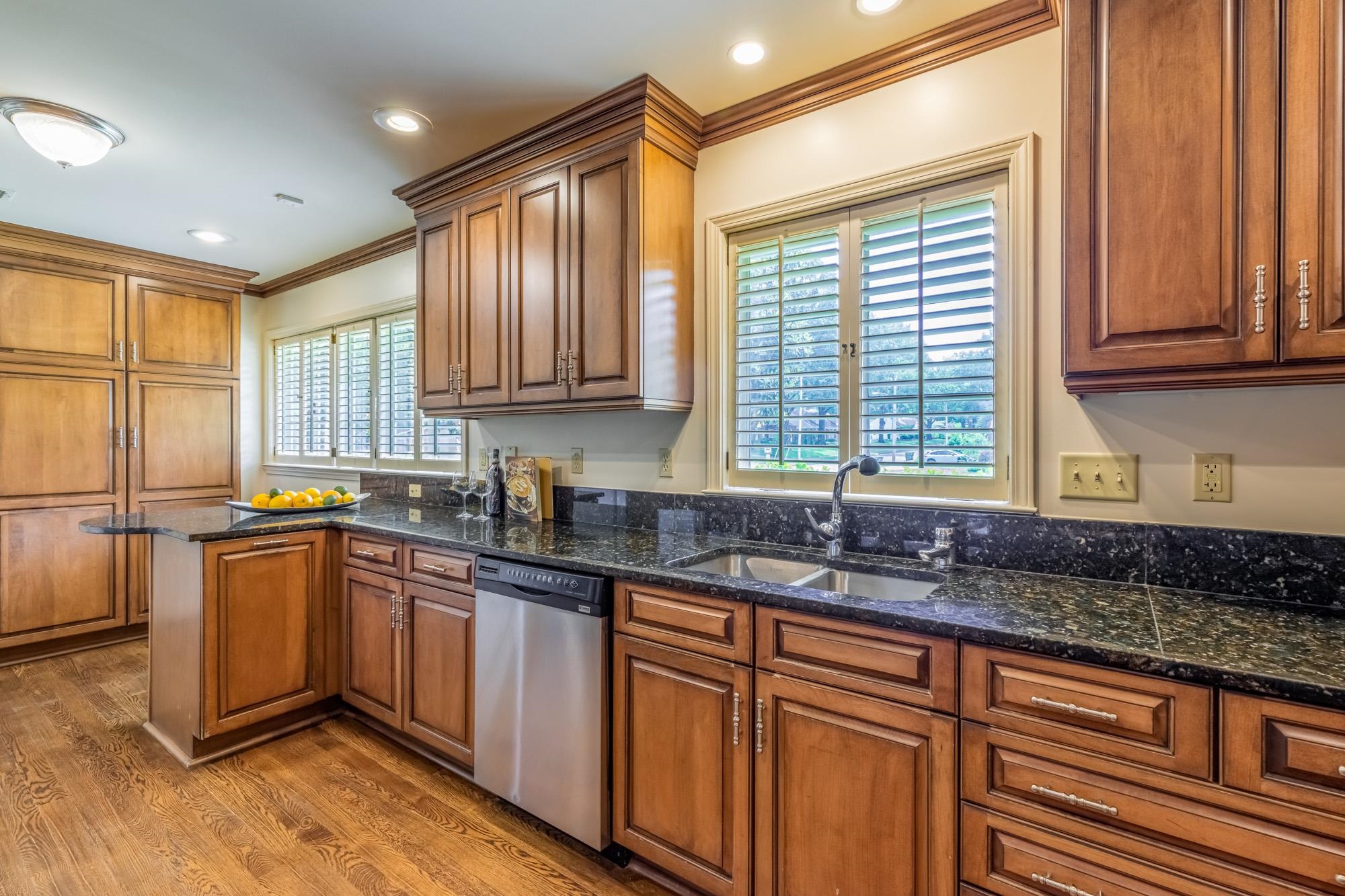 4174 Minden Road Memphis, TN 38117 - Photo 8 of 24 a kitchen with granite countertop wooden cabinets a sink and a window