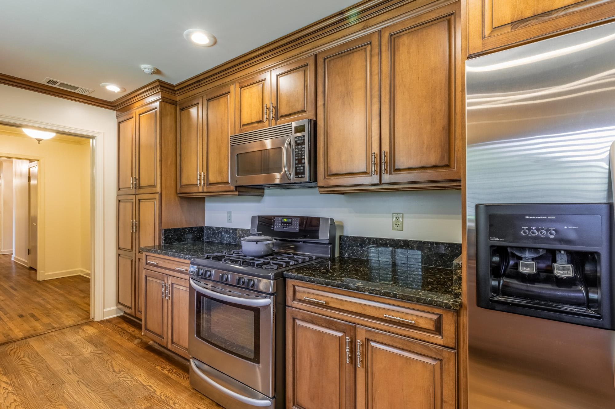 4174 Minden Road Memphis, TN 38117 - Photo 9 of 24 a kitchen with stainless steel appliances granite countertop a stove a sink and a microwave
