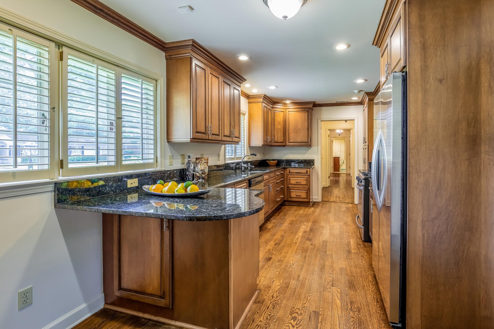 4174 Minden Road Memphis, TN 38117 - Photo 10 of 24 a kitchen with stainless steel appliances granite countertop a sink a stove and a wooden floors