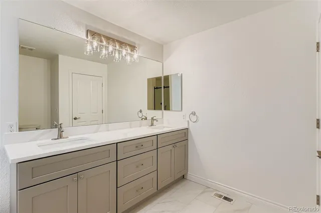 a bathroom with a double vanity sink and mirror