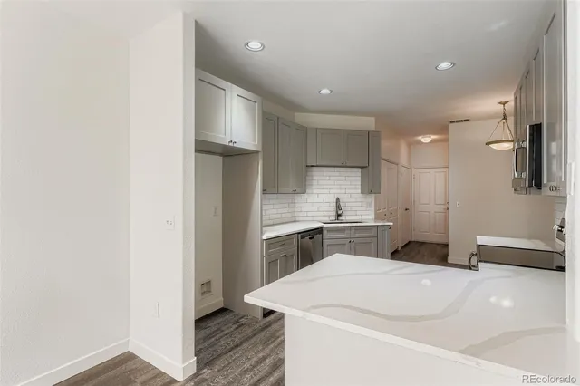 a kitchen with a refrigerator and a sink