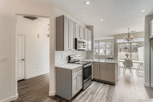 a kitchen with a sink stove and cabinets
