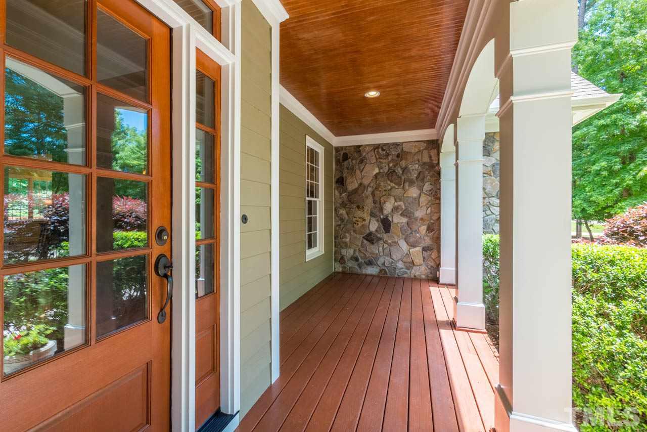 9512 Ray Road Raleigh, NC 27613 - Photo 2 of 25 a view of a porch with wooden floor