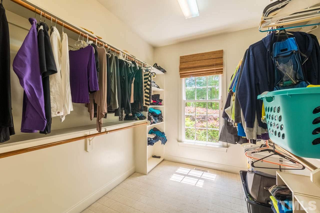 9512 Ray Road Raleigh, NC 27613 - Photo 13 of 25 a view of walk in closet with clothes and shoes