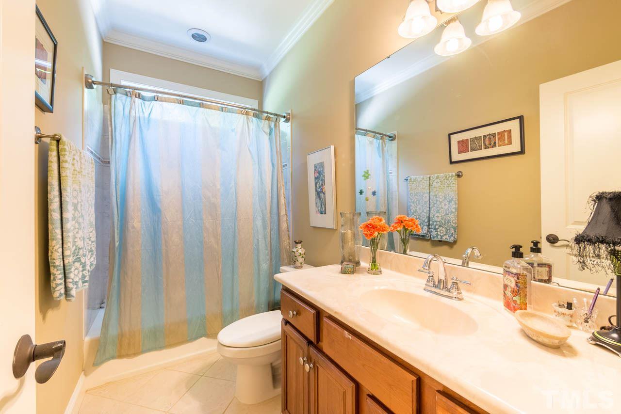 9512 Ray Road Raleigh, NC 27613 - Photo 15 of 25 a bathroom with a sink toilet and shower