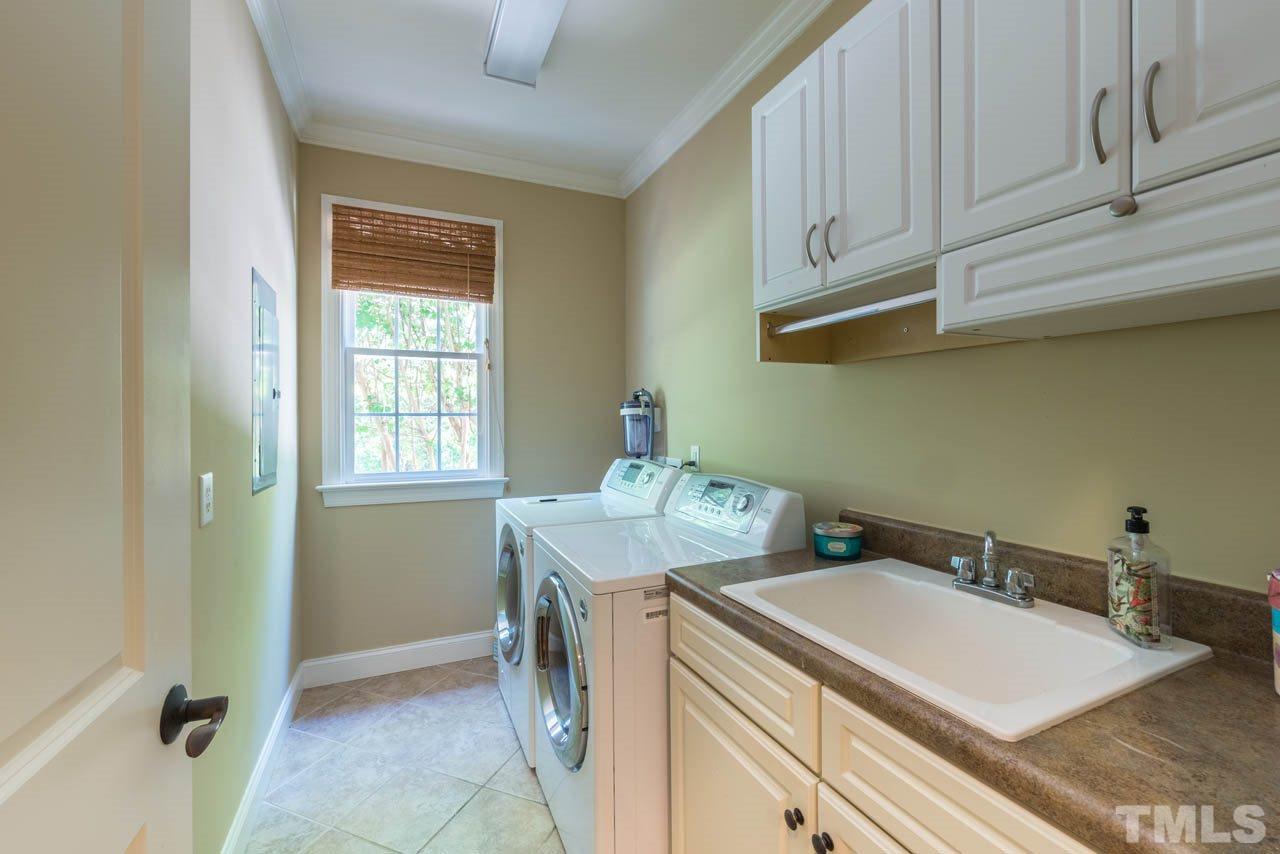 9512 Ray Road Raleigh, NC 27613 - Photo 16 of 25 a utility room with sink dryer and washer