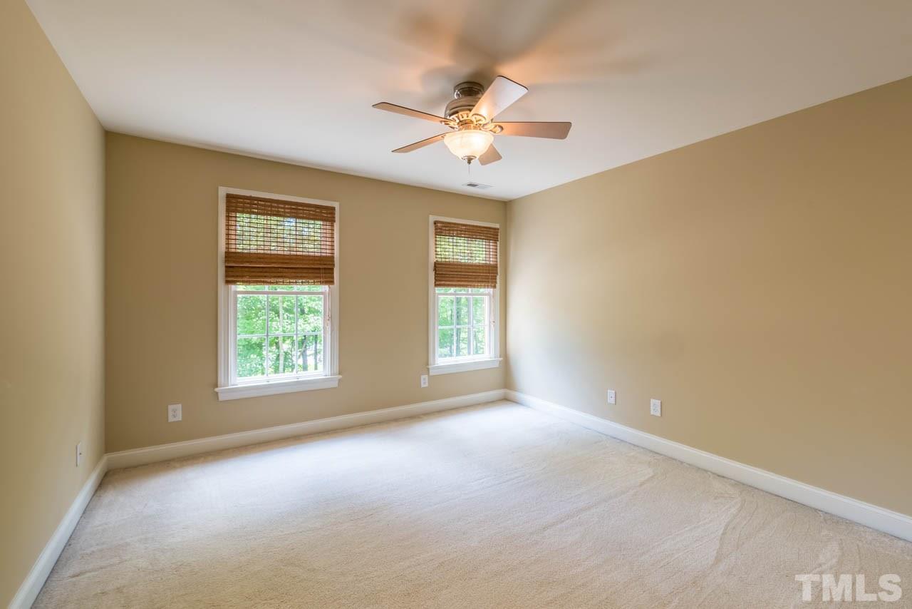 9512 Ray Road Raleigh, NC 27613 - Photo 18 of 25 an empty room with a window and a ceiling fan