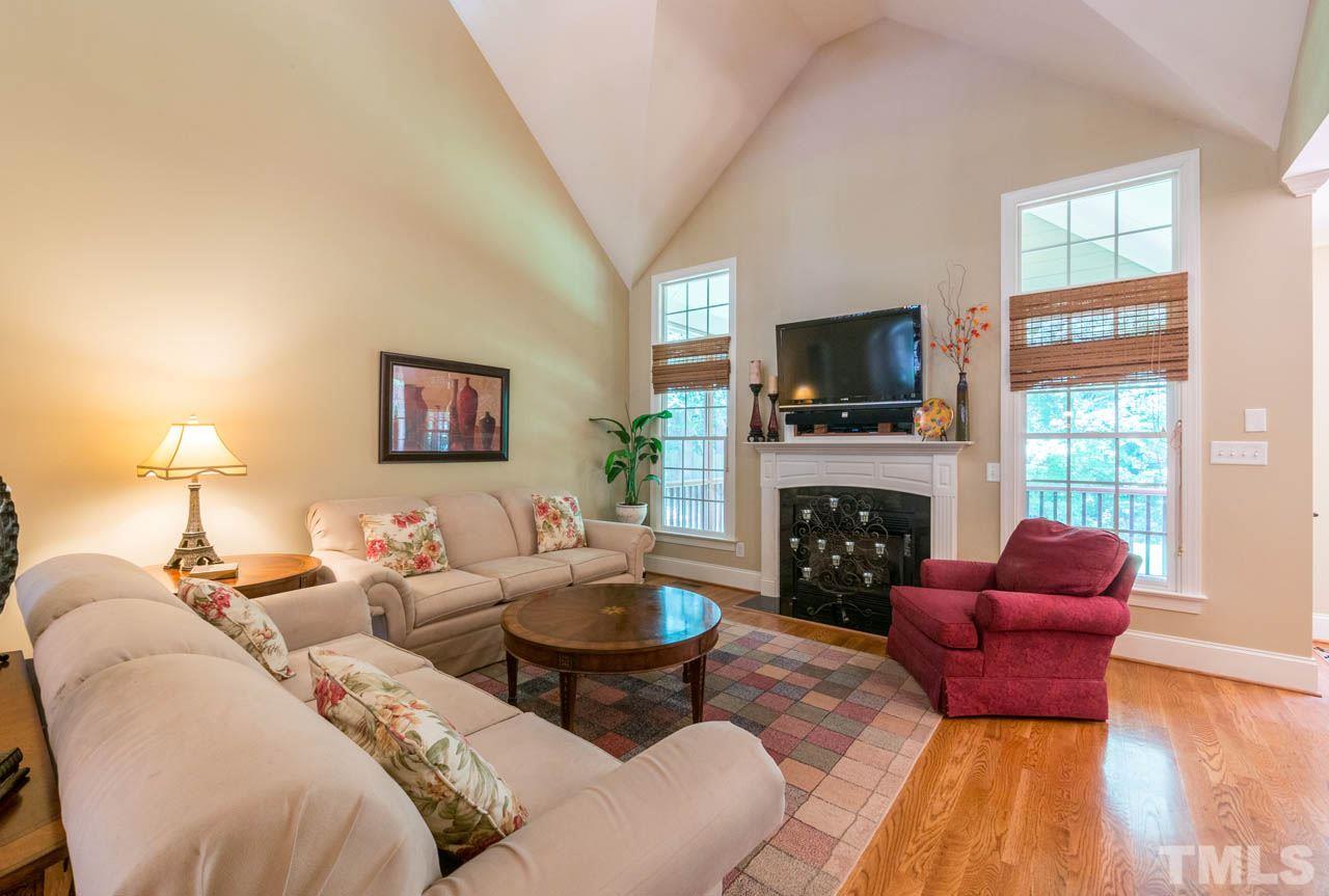 9512 Ray Road Raleigh, NC 27613 - Photo 5 of 25 a living room with furniture a fireplace and a flat screen tv