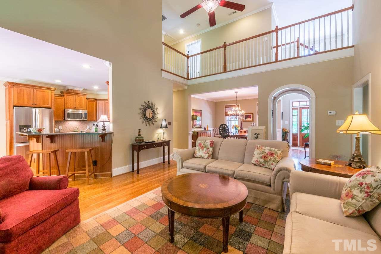 9512 Ray Road Raleigh, NC 27613 - Photo 6 of 25 a living room with furniture and a chandelier