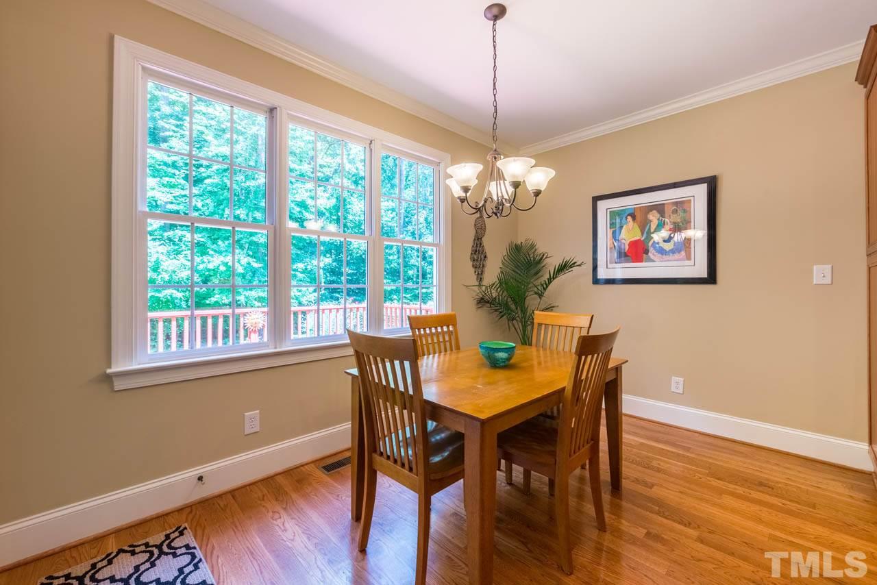 9512 Ray Road Raleigh, NC 27613 - Photo 9 of 25 a view of a dining room with furniture window and wooden floor