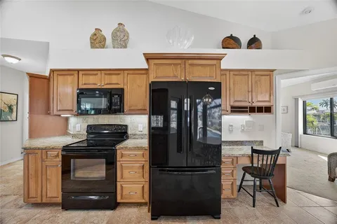 a kitchen with a refrigerator and a stove top oven