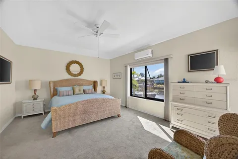 a bedroom with a large bed and flat tv screen on dresser