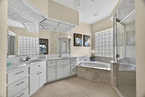a bathroom with a granite countertop sink mirror and a bathtub