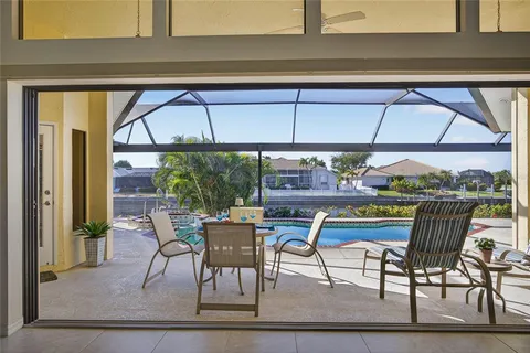 a view of a patio with a table and chairs