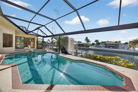a view of a swimming pool with porch and garden