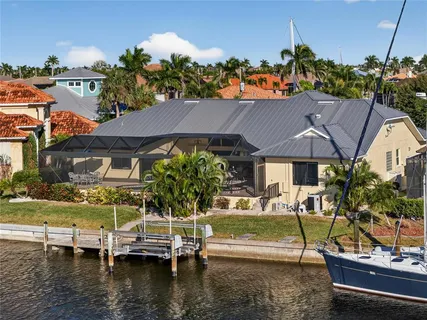 an aerial view of a house with swimming pool patio and outdoor seating