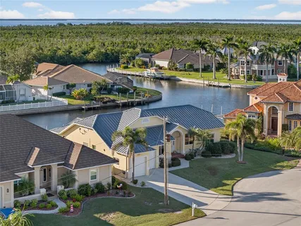 a aerial view of a house with a yard and balcony