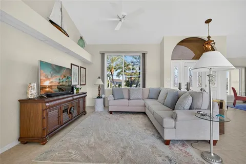 a living room with furniture and a chandelier