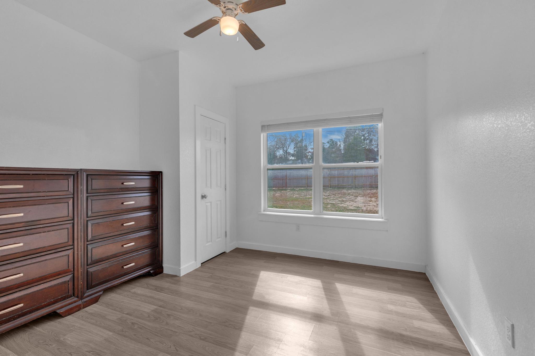 114 Crepe Myrtle Parkway Elgin, TX 78621 - Photo 13 of 40 Unit A - Unfurnished bedroom with light wood finished floors and ceiling fan