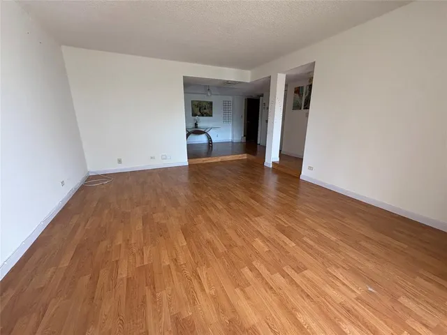 a kitchen with stainless steel appliances granite countertop a refrigerator a sink a stove with wooden floor