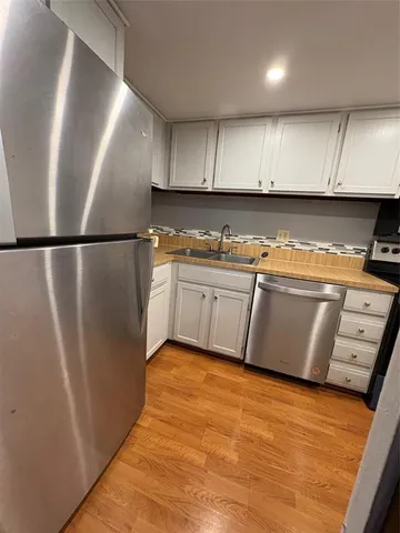 a kitchen with stainless steel appliances granite countertop a stove sink and cabinets