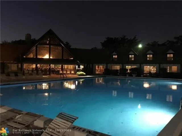 a view of a swimming pool with seating area