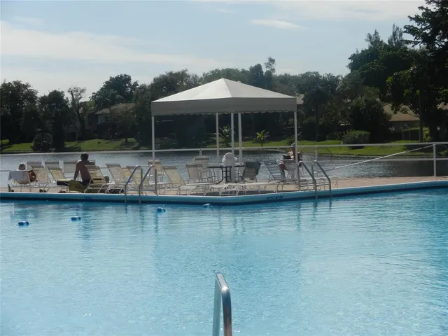 an outdoor space with swimming pool and furniture