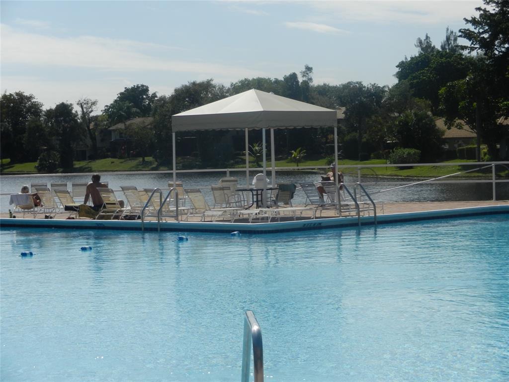 3670 Inverrary Drive, Unit 3B Lauderhill, FL 33319 - Photo 5 of 22 an outdoor space with swimming pool and furniture