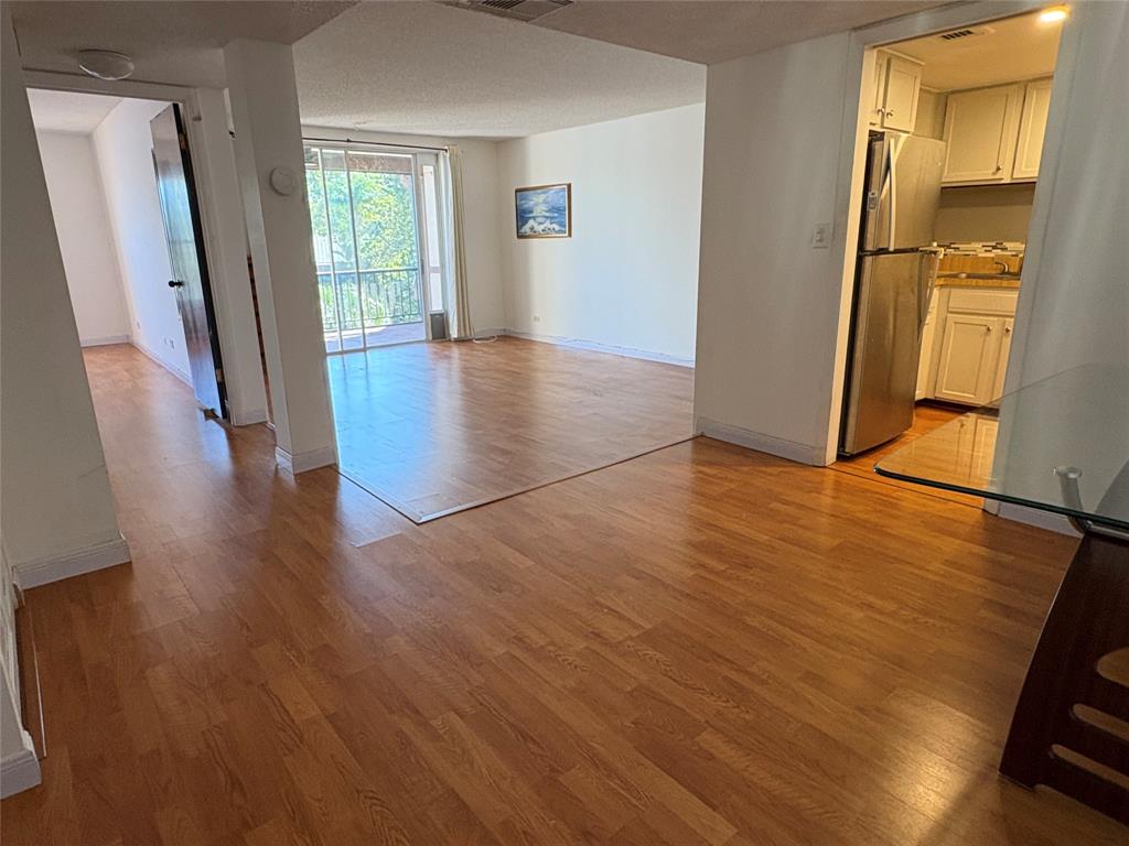 3670 Inverrary Drive, Unit 3B Lauderhill, FL 33319 - Photo 7 of 22 an empty room with wooden floor and a window