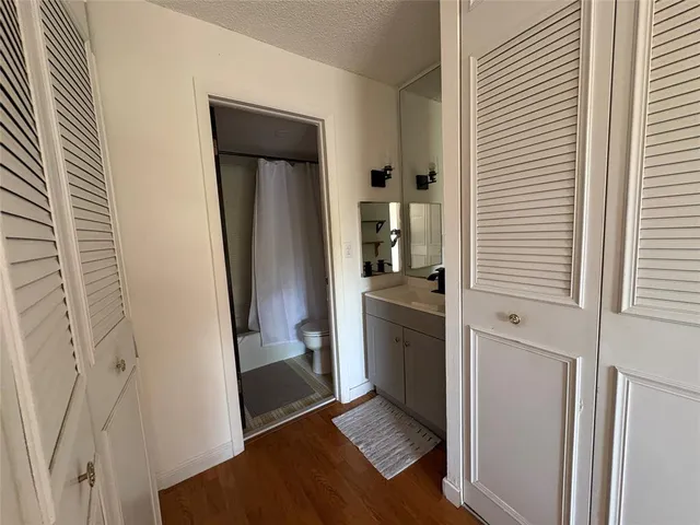 an empty room with wooden floor and a window