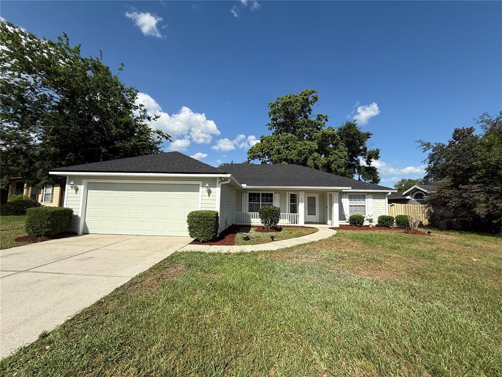 a front view of a house with a yard and garage