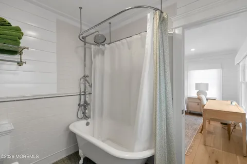 a bathroom with a granite countertop shower sink vanity and mirror