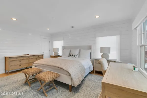 a bathroom with a granite countertop shower sink vanity and mirror