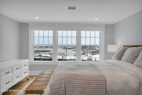 a spacious bedroom with a bed and a cabinets