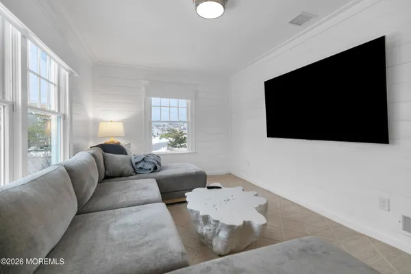 a spacious bedroom with a bed and a cabinets