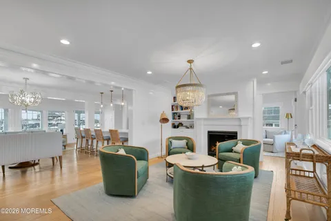 a living room with fireplace furniture and a wooden floor