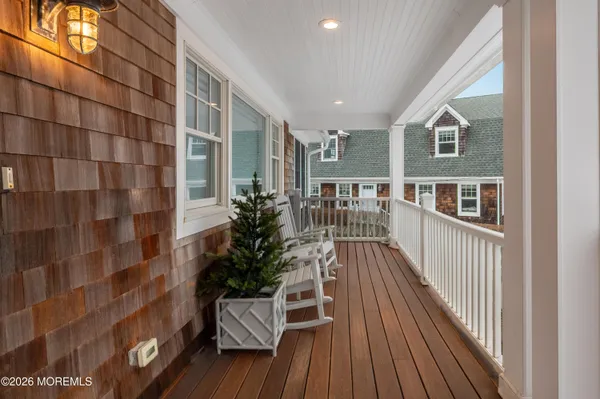 a view of balcony with wooden floor and bench