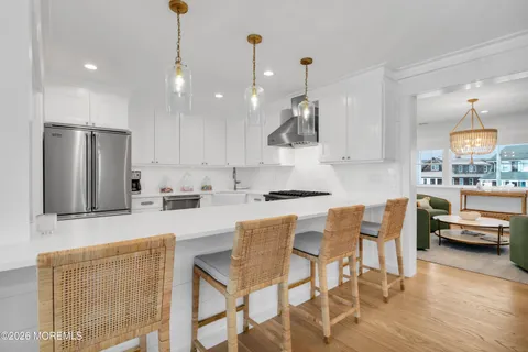 a kitchen with stainless steel appliances a stove a sink and a refrigerator