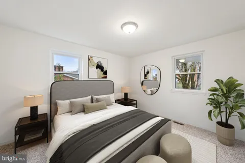 a bedroom with a bed and a potted plant