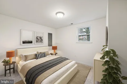 a bedroom with a bed and a painting on the wall