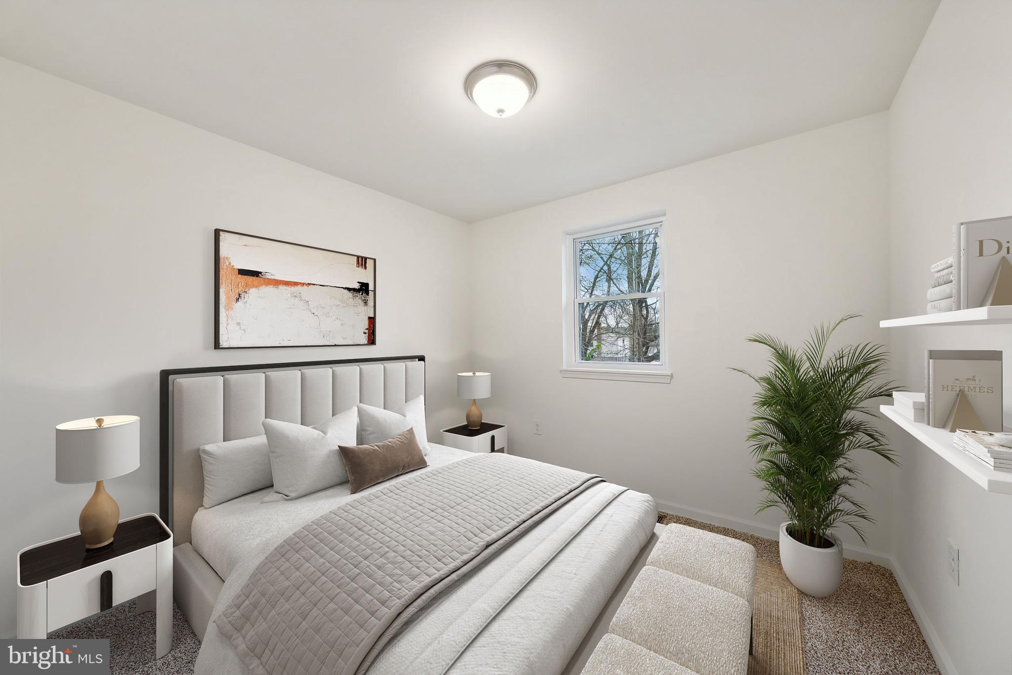 6205 Brooke Jane Drive Clinton, MD 20735 - Photo 7 of 26 a bedroom with a large bed and a potted plant