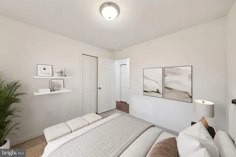 a bedroom with a bed and a potted plant