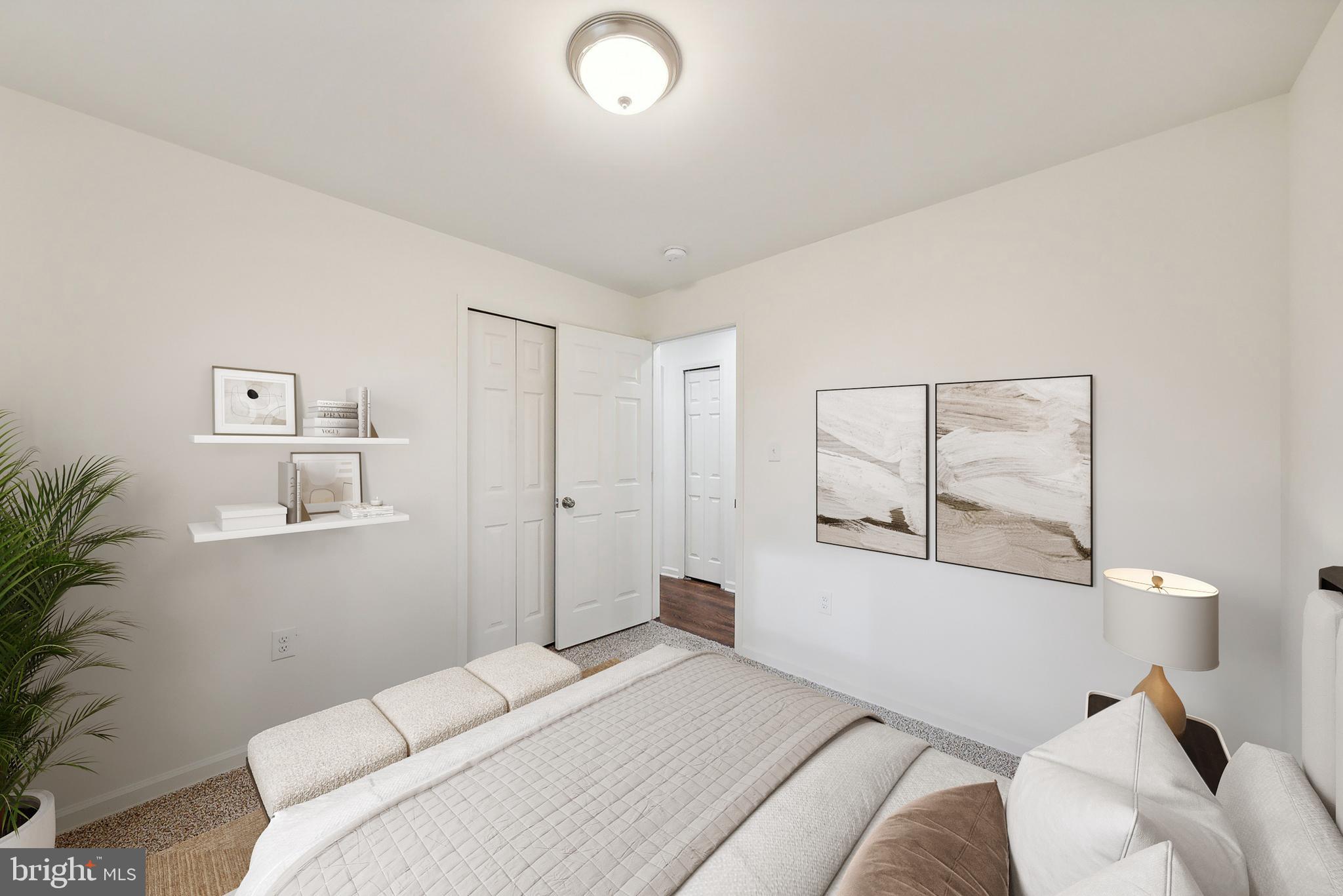 6205 Brooke Jane Drive Clinton, MD 20735 - Photo 8 of 26 a bedroom with a bed and a potted plant