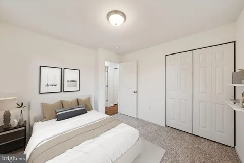 a bedroom with a bed and a painting on the wall