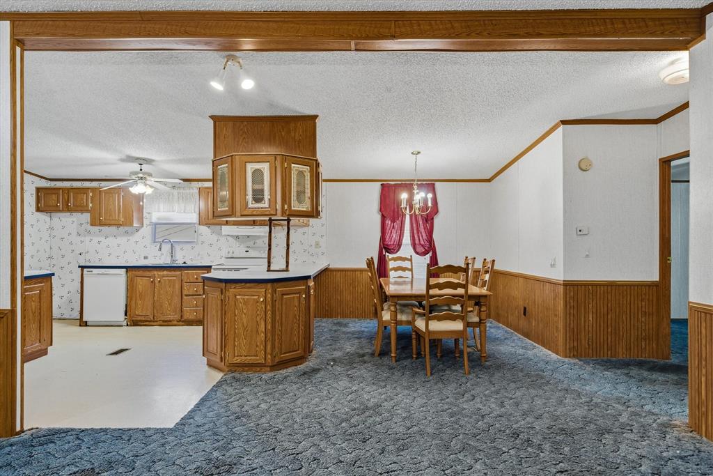 220 North Houston Street Edgewood, TX 75117 - Photo 11 of 30 a kitchen with a sink cabinets and wooden floor