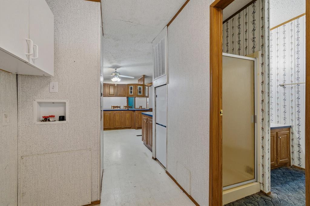 220 North Houston Street Edgewood, TX 75117 - Photo 15 of 30 a view of a kitchen from the hallway