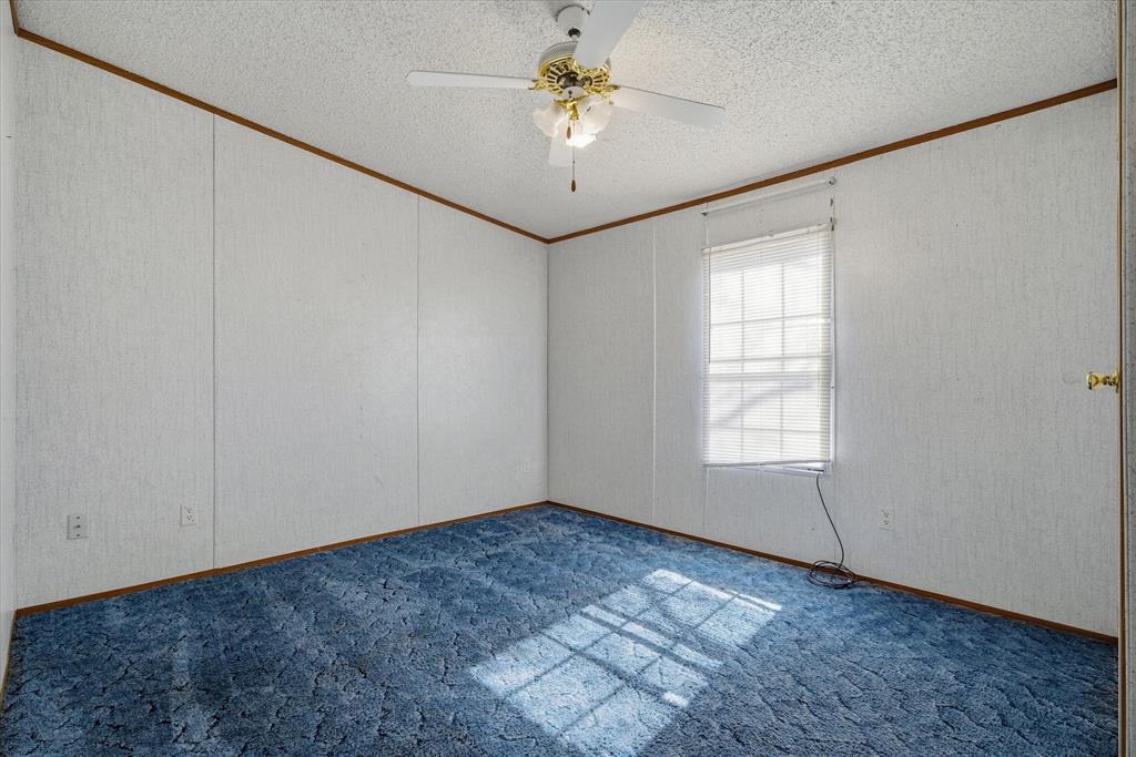 220 North Houston Street Edgewood, TX 75117 - Photo 21 of 30 an empty room with windows and fan