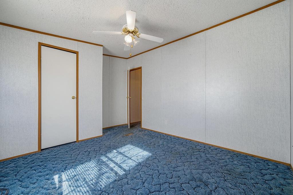 220 North Houston Street Edgewood, TX 75117 - Photo 22 of 30 a view of an empty room with a chandelier fan