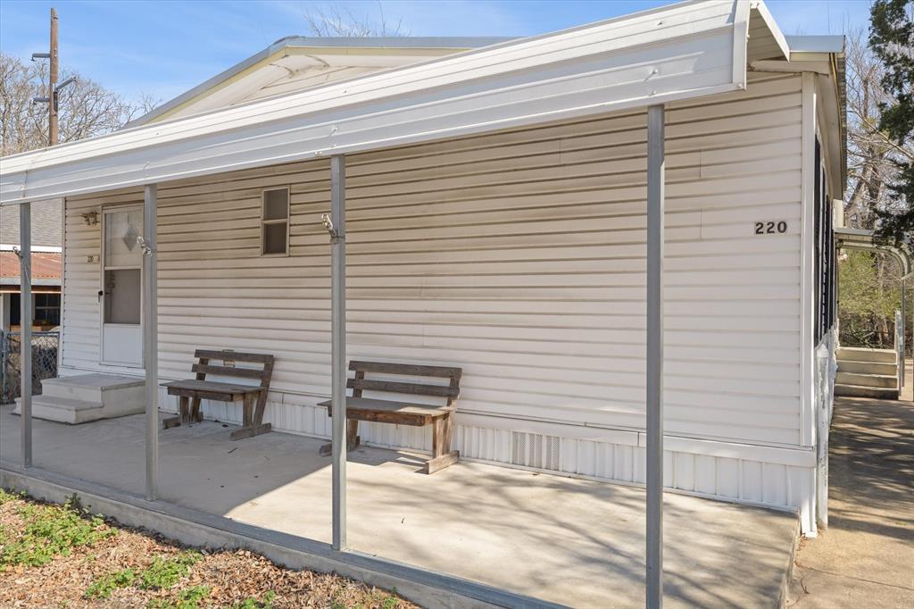 220 North Houston Street Edgewood, TX 75117 - Photo 24 of 30 a view of a patio with couches chairs and wooden floor