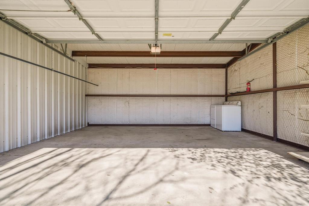 220 North Houston Street Edgewood, TX 75117 - Photo 28 of 30 a view of a parking space with a utility room